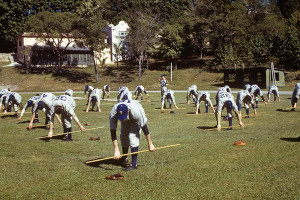 Brooklyn Dodger players use poles and not baseball bats as they twist and turn the core of their bodies for Spring Training exercise in the Cerveza Tropical Stadium in Cuba.