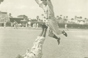 (On back, Hugh Casey; Mid-Air, Al Campanis). Brooklyn Dodger pitcher Hugh Casey helps infielder Al Campanis get air during a Spring Training exercise in Cuba.