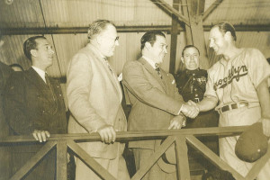 (L-R, Unidentified; Brooklyn Dodger President Larry MacPhail; Cuban President Fulgencio Batista; Brooklyn Dodger Manager Leo Durocher). Leo Durocher shakes hands with the President of Cuba, Fulgencio Batista, as Dodger President Larry MacPhail looks on.