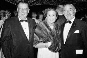 Walter O’Malley with his wife Kay are greeted by Warner Bros. co-founder Jack Warner (right) at the star-studded Hollywood premiere of 'My Fair Lady' on October 28, 1964.