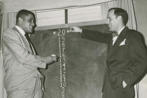 (L-R) Don Newcombe; Dodger Vice President Buzzie Bavasi. Don Newcombe, the ace of the Brooklyn Dodger staff and Dodger Vice President Buzzie Bavasi both try to estimate Newcombe’s win total for the coming season with Bavasi pointing to a hope of 20 wins.