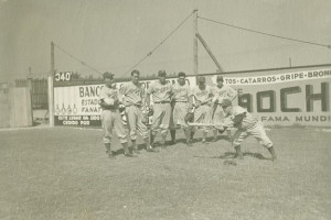 Assorted Brooklyn Dodger players watch as Eddie Stanky shows good form in the method of handling the bat on a low pitch to make a proper bunt.